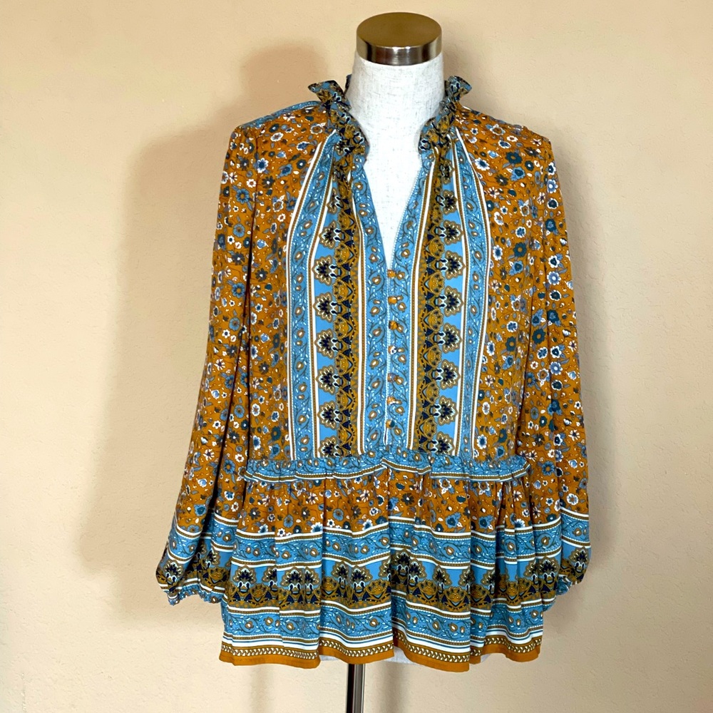 Spring/Summer floral peplum blouse and ruffle and fabric button details.